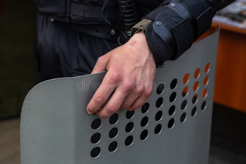 Ukrainian police officer with a metal shield at the protest stock photos Ukrainian police officer with a metal shield at the protest stock photos