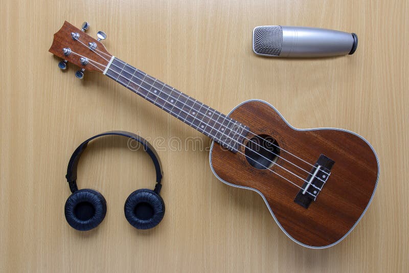 Ukulele and Microphone with Wires on Blue and Yellow Background. the