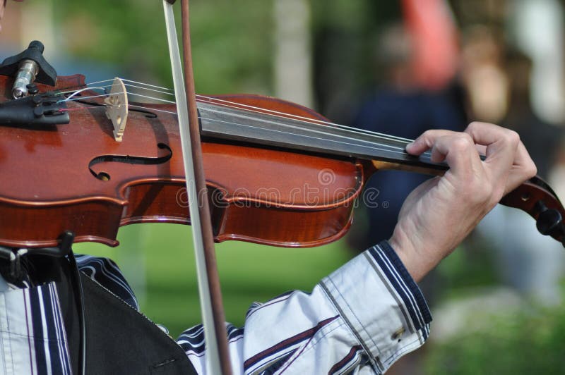 Man who play violin on the street. Man who play violin on the street