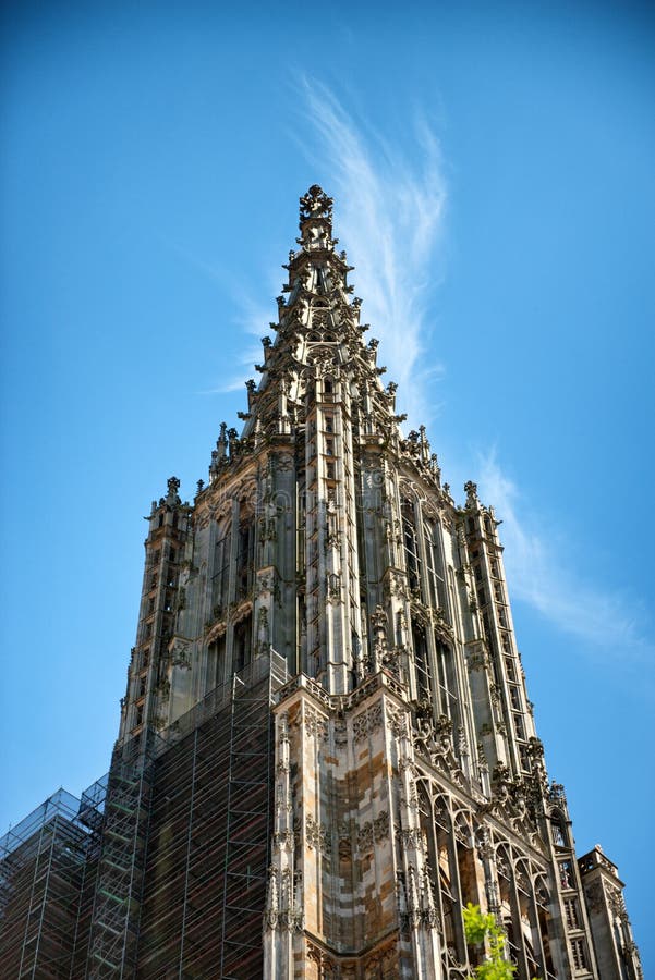 Low angle view of Ulmer Munster (Minster) tower against blue sky in Ulm, Germany. Low angle view of Ulmer Munster (Minster) tower against blue sky in Ulm, Germany