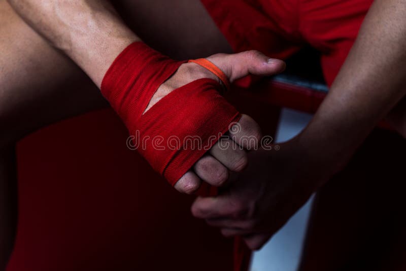 Ultimate Fighter Putting Straps On His Hands stock photo Ultimate Fighter Putting Straps On His Hands stock photo