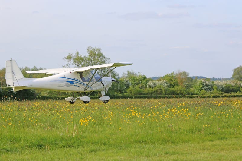 Ultralight Airplane Landing on a Grass Strip Stock Photo Image of