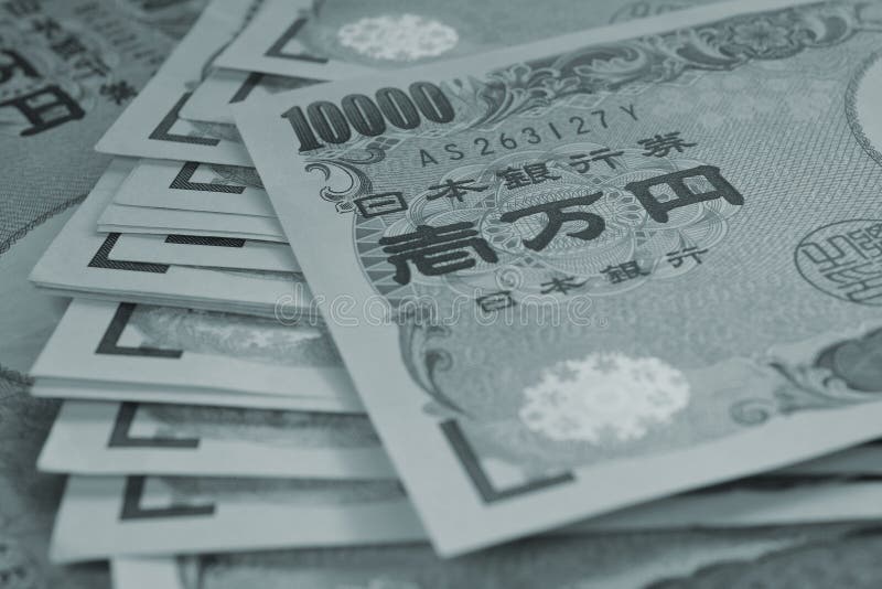 A field of 10000 yen Japanese notes. Tinted grey or gray-blue background with low contrast. A heap of banknotes. Dark backdrop on the theme of banks, finance and the economy of Japan. Macro. A field of 10000 yen Japanese notes. Tinted grey or gray-blue background with low contrast. A heap of banknotes. Dark backdrop on the theme of banks, finance and the economy of Japan. Macro