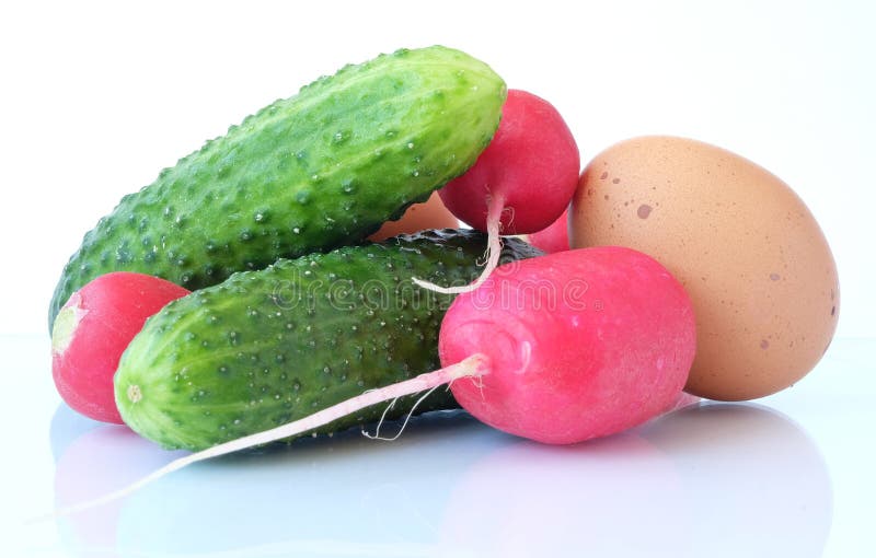 A set of basic ingredients for preparing a vitamin salad on a light background. The set of vegetables includes radish, chicken eggs and cucumber. Usually, young onions, parsley and dill are added to the vegetable salad, everything is finely chopped and greased with vegetable oil, ground black pepper, salt, and spices are added to taste. Red and green colors predominate. A set of basic ingredients for preparing a vitamin salad on a light background. The set of vegetables includes radish, chicken eggs and cucumber. Usually, young onions, parsley and dill are added to the vegetable salad, everything is finely chopped and greased with vegetable oil, ground black pepper, salt, and spices are added to taste. Red and green colors predominate.