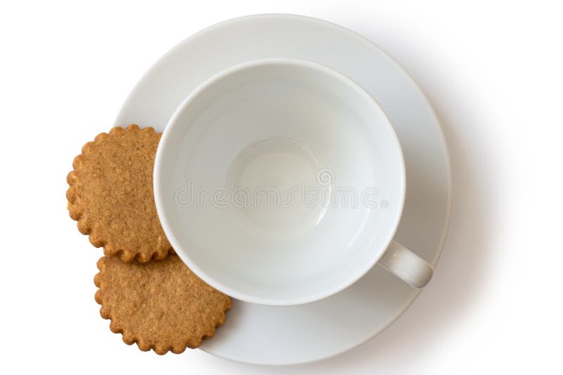 Um copo e uns pires cerâmicos brancos vazios com o biscu de dois pão-de-espécie fotografia de stock royalty free Um copo e uns pires cerâmicos brancos vazios com o biscu de dois pão-de-espécie fotografia de stock royalty free