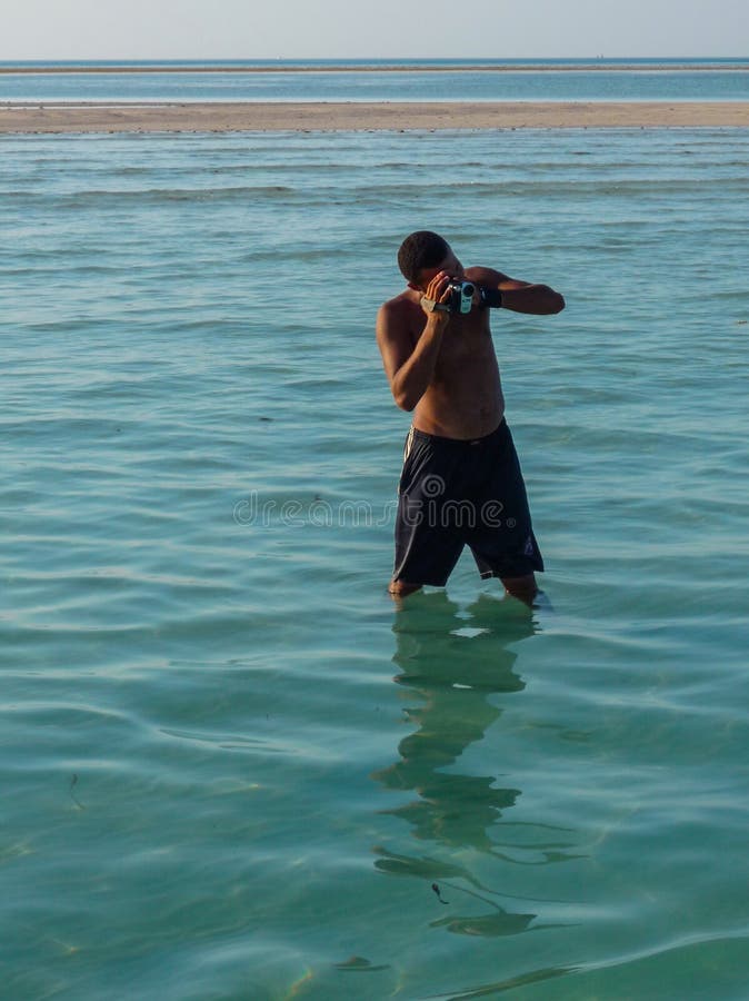 Um fotógrafo novo toma fotos dos turistas para a memória Egypt Hurghada Julho de 2009 fotos de stock Um fotógrafo novo toma fotos dos turistas para a memória Egypt Hurghada Julho de 2009 fotos de stock