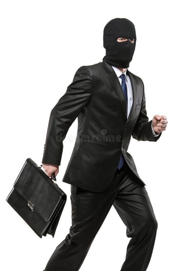 Um homem na máscara da extorsão que carreg uma pasta fotografia de stock royalty free Um homem na máscara da extorsão que carreg uma pasta fotografia de stock royalty free