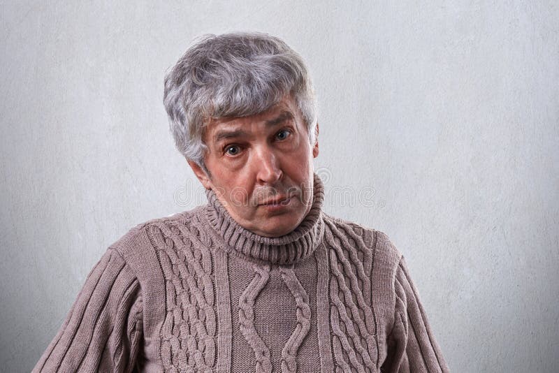 Um homem velho com os enrugamentos que têm o cabelo cinzento vestido na camiseta que tem a expressão simpática isolado sobre o fu foto de stock royalty free Um homem velho com os enrugamentos que têm o cabelo cinzento vestido na camiseta que tem a expressão simpática isolado sobre o fu foto de stock royalty free