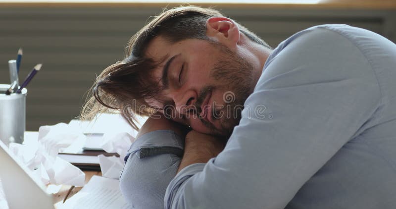 Um jovem empresário preguiçoso e cansado adormeceu no local de trabalho.