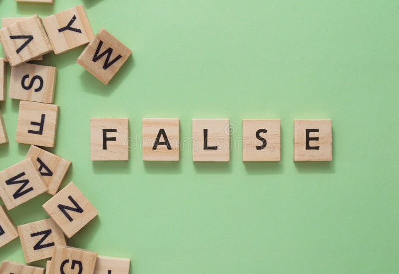 A jumble of wooden letters spell out the word false. The letters are scattered across the image, with some overlapping each other. Scene is one of confusion and disarray. A jumble of wooden letters spell out the word false. The letters are scattered across the image, with some overlapping each other. Scene is one of confusion and disarray