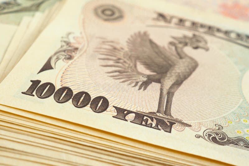 A bundle of 10000 yen Japanese bills. The reverse of the banknote with the image of the Phoenix bird close-up. Illustration on the theme of money  banks  finance and the economy of Japan. Macro. A bundle of 10000 yen Japanese bills. The reverse of the banknote with the image of the Phoenix bird close-up. Illustration on the theme of money  banks  finance and the economy of Japan. Macro