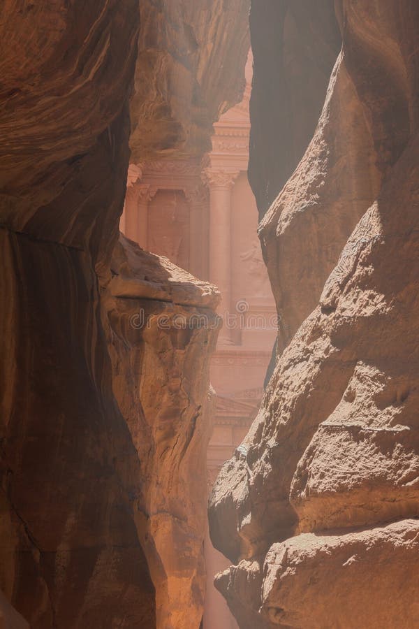 A first glimpse of the treasury, seen through the dusty mist hanging in the Siq. A first glimpse of the treasury, seen through the dusty mist hanging in the Siq