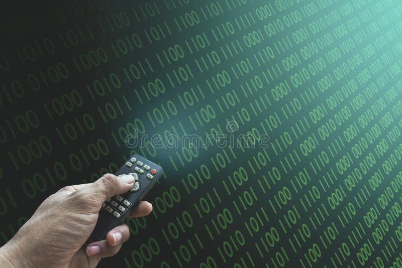 A male programmer hand is pressing a remote control to control a computer in a hacked password on binary number Pattern matrix cybercrime background green color with numbers 1, 0. Cyber theft concept. A male programmer hand is pressing a remote control to control a computer in a hacked password on binary number Pattern matrix cybercrime background green color with numbers 1, 0. Cyber theft concept.