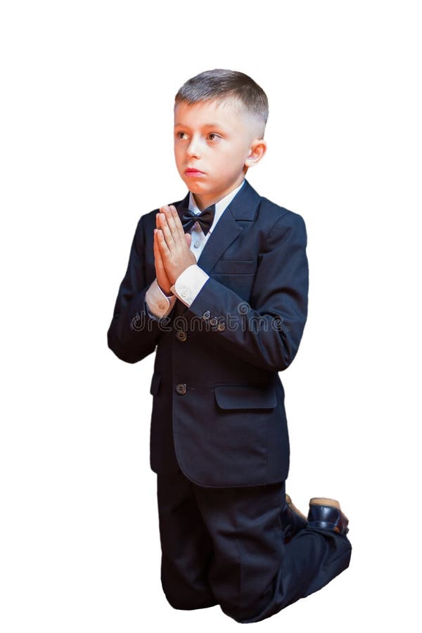 Um rapaz pequeno em um terno que reza, isolado em um fundo branco foto de stock royalty free Um rapaz pequeno em um terno que reza, isolado em um fundo branco foto de stock royalty free