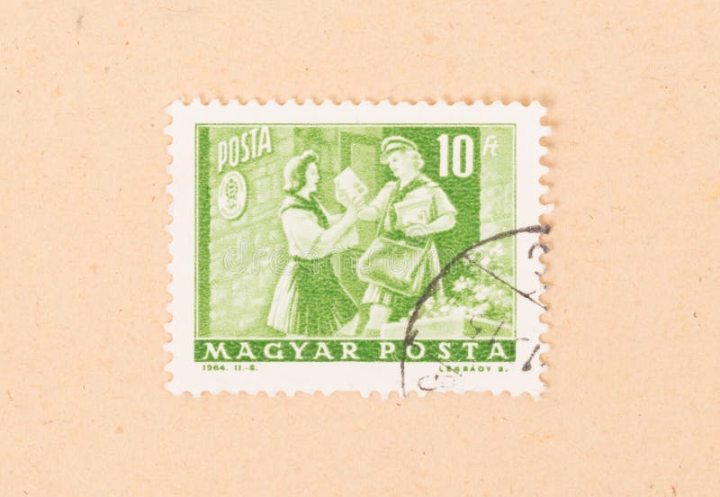 Um selo impresso em Hungria mostra o serviço húngaro do porte postal, cerca de 1964 imagens de stock Um selo impresso em Hungria mostra o serviço húngaro do porte postal, cerca de 1964 imagens de stock