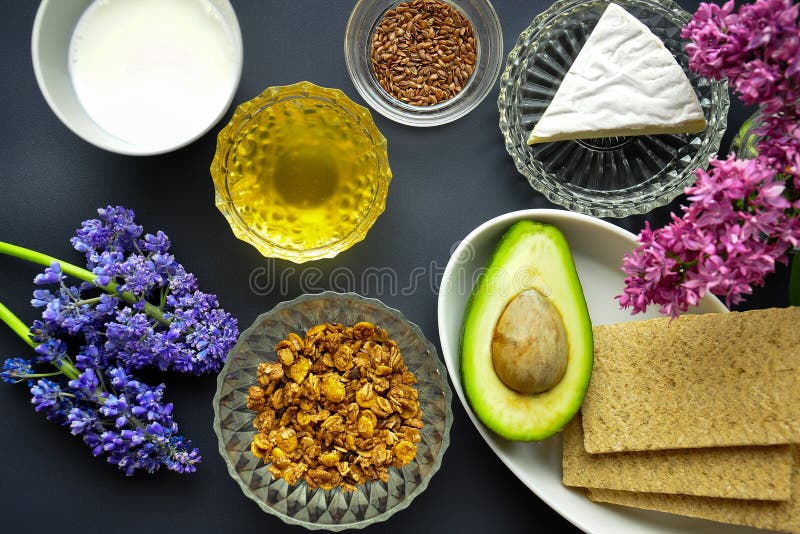 Uma bacia de cereal com as sementes crouted da farinha de aveia e do leite e de linho, mel, queijo, brinde com abacate, panqueca imagens de stock royalty free Uma bacia de cereal com as sementes crouted da farinha de aveia e do leite e de linho, mel, queijo, brinde com abacate, panqueca imagens de stock royalty free