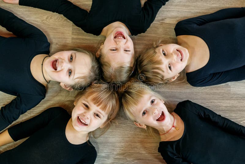 A team of young children do gymnastics in a dance class. The concept of sport, education, childhood, hobbies and dance,. A team of young children do gymnastics in a dance class. The concept of sport, education, childhood, hobbies and dance,