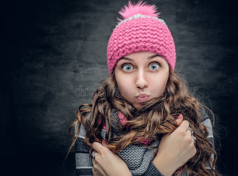 Uma menina no chapéu do inverno com maravilha em sua cara fotografia de stock royalty free Uma menina no chapéu do inverno com maravilha em sua cara fotografia de stock royalty free