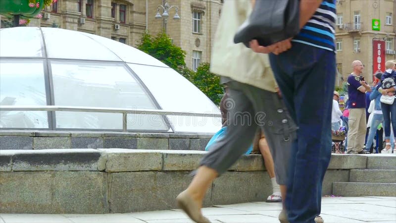 Uma mulher desabrigada bêbado está sentando-se na rua, ondulada acima