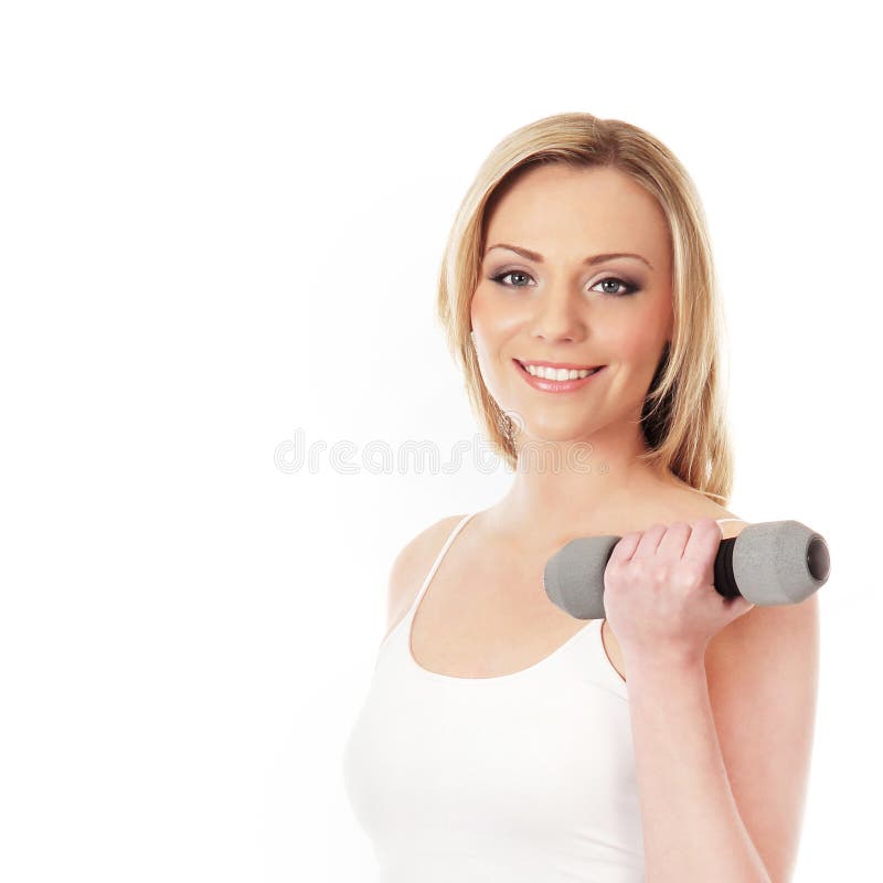 Uma mulher loura e apta nova que prende um dumbbell foto de stock Uma mulher loura e apta nova que prende um dumbbell foto de stock