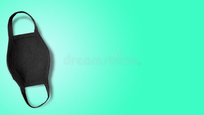 A black medical mask to prevent from COVID-19 or corona virus with greenish blue color in background. It can be used to be safe from almost all viruses and bacteria. A black medical mask to prevent from COVID-19 or corona virus with greenish blue color in background. It can be used to be safe from almost all viruses and bacteria