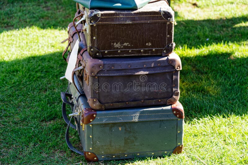 Suitcases for sale, three suitcases piled up await a buyer. Suitcases for sale, three suitcases piled up await a buyer