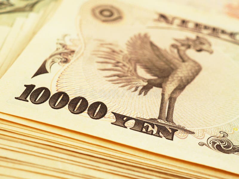 A pile of 10000 yen Japanese banknotes. The reverse of the banknote with the image of the Phoenix bird close-up. Contrast and saturated illustration about money and the economy of Japan. Macro. A pile of 10000 yen Japanese banknotes. The reverse of the banknote with the image of the Phoenix bird close-up. Contrast and saturated illustration about money and the economy of Japan. Macro