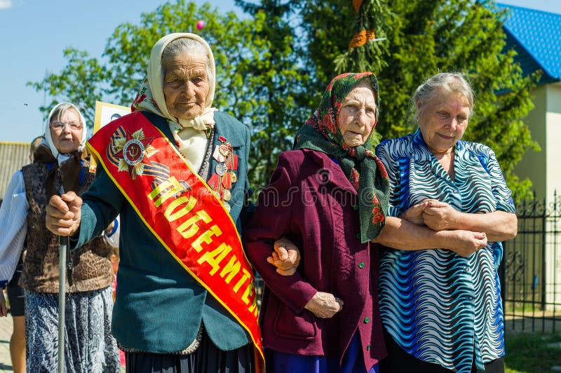 A solemn meeting in honor of Victory Day in World war 2 may 9, 2016 in the Kaluga region in Russia. In celebration of the victory over Nazi Germany in all cities, towns and villages of Russia held a solemn meeting with participation of the local population, administration employees and veterans of the 1941-1945 war. Meetings are held on the places of military glory and the memorials and the mass graves near them installed on sites where speeches, veterans share memories of war, observed a minute of silence, and came to lay wreaths to the monuments and flowers as a tribute to fallen soldiers. A solemn meeting in honor of Victory Day in World war 2 may 9, 2016 in the Kaluga region in Russia. In celebration of the victory over Nazi Germany in all cities, towns and villages of Russia held a solemn meeting with participation of the local population, administration employees and veterans of the 1941-1945 war. Meetings are held on the places of military glory and the memorials and the mass graves near them installed on sites where speeches, veterans share memories of war, observed a minute of silence, and came to lay wreaths to the monuments and flowers as a tribute to fallen soldiers.