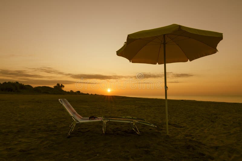 Umbrella on the Beach at Sunset Stock Photo Image of solitude, waves