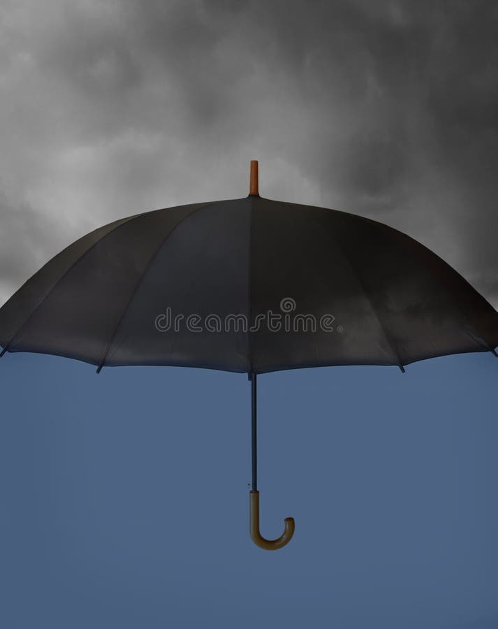 Umbrella with heavy clouds royalty free stock images