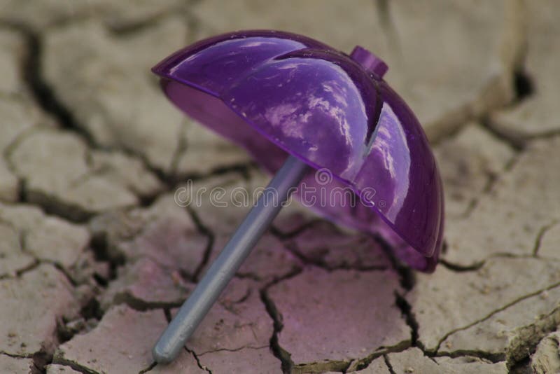 Umbrella on parched ground stock photo. Image of chapped 99604790