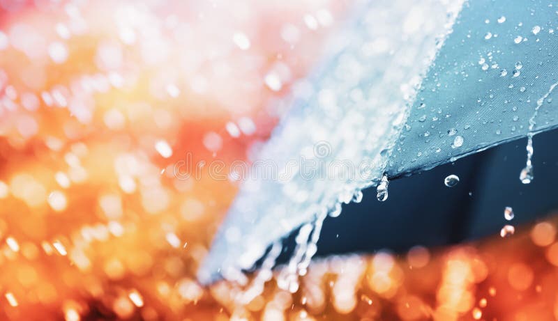 Umbrella under heavy rain against nature background. Autumn weather concept. Selective focus stock images Umbrella under heavy rain against nature background. Autumn weather concept. Selective focus stock images