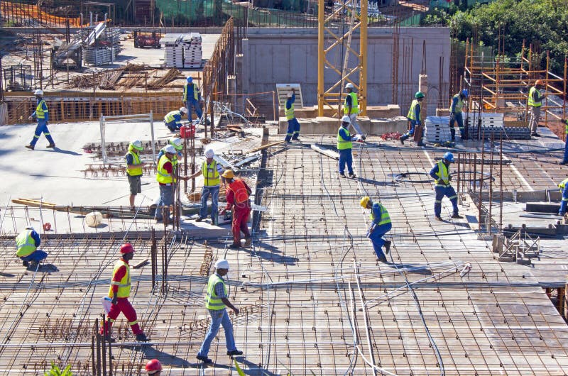 DURBAN, SOUTH AFRICA-NOVEMBER 2 2013: Twenty one workmen and management team working on construction site at Umhlanga Ridge on November 2 2013 in Durban South Africa. DURBAN, SOUTH AFRICA-NOVEMBER 2 2013: Twenty one workmen and management team working on construction site at Umhlanga Ridge on November 2 2013 in Durban South Africa