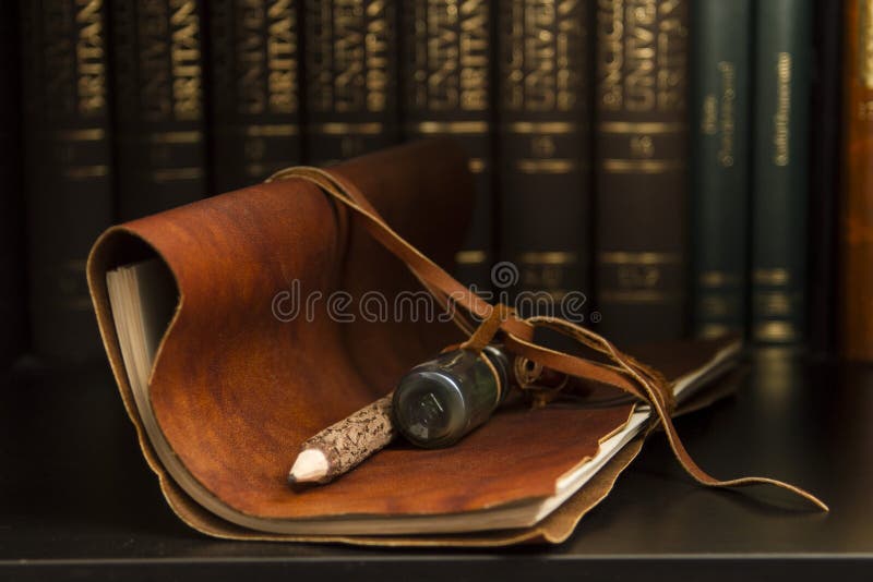 A dusty leather diary and wooden pencil. A dusty leather diary and wooden pencil