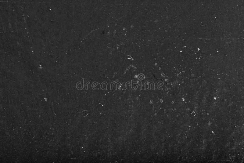 Black dusty abstract background. the old black film paper texture. Grungy textured blackboard. Black dusty abstract background. the old black film paper texture. Grungy textured blackboard.