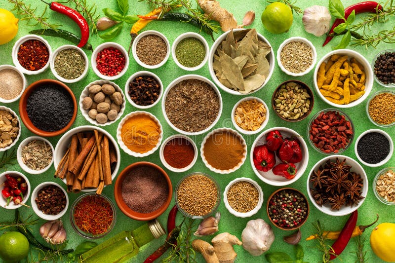 Un assortimento colorato di spezie e erbe fragranti fresche in uno sfondo verde morbido che cattura un vibrante fotografie stock