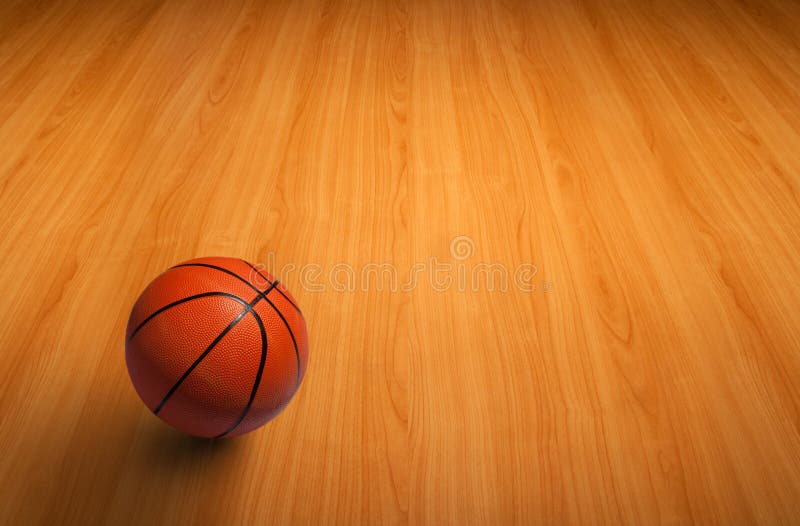 Un baloncesto en suelo de madera fotografía de archivo Un baloncesto en suelo de madera fotografía de archivo