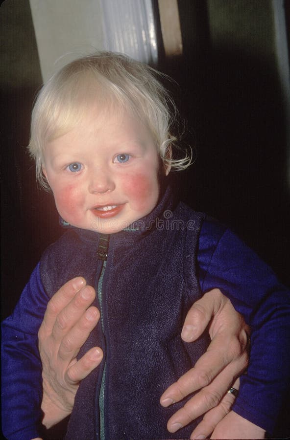 A baby with rosy cheeks. A baby with rosy cheeks