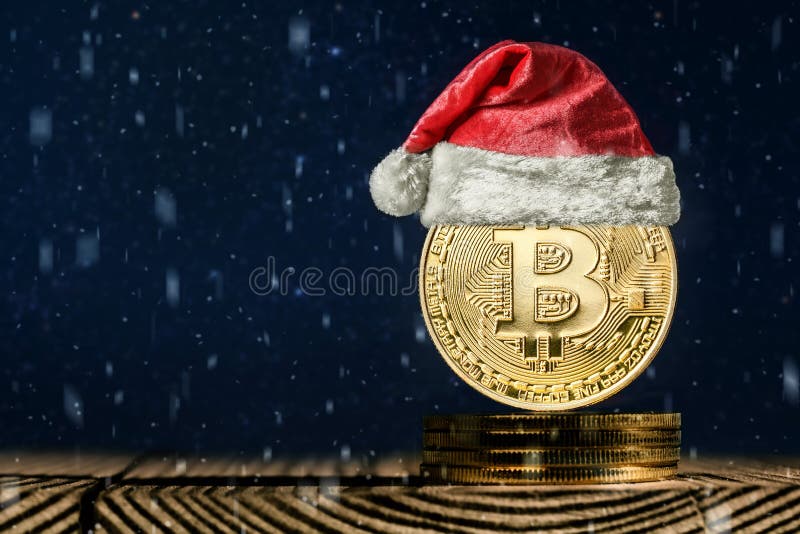 Un bitcoin en los fondos de la Navidad imagenes de archivo