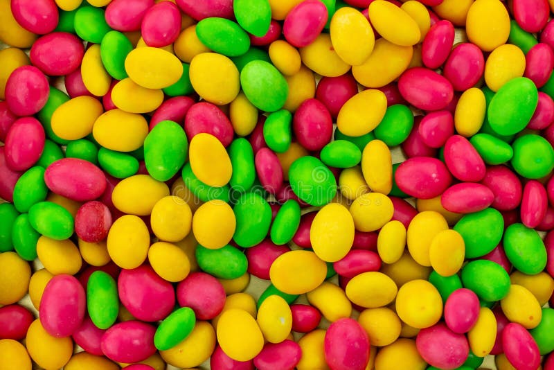 Un bon nombre colorés lumineux de fond de dragées multicolores jaunes vertes de rose de bonbons basent la conception de fête photographie stock Un bon nombre colorés lumineux de fond de dragées multicolores jaunes vertes de rose de bonbons basent la conception de fête photographie stock