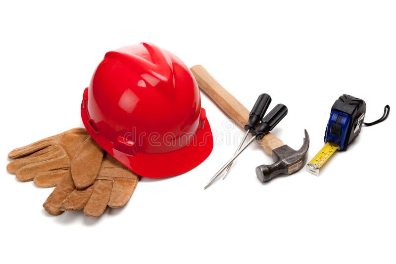 A red hard hat and leather work gloves with tools including a hammer, screwdrivers and a tape measureon a white background. A red hard hat and leather work gloves with tools including a hammer, screwdrivers and a tape measureon a white background