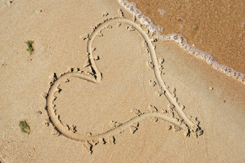 Love and feelings. A heart drawn on wet sand. Love and feelings. A heart drawn on wet sand