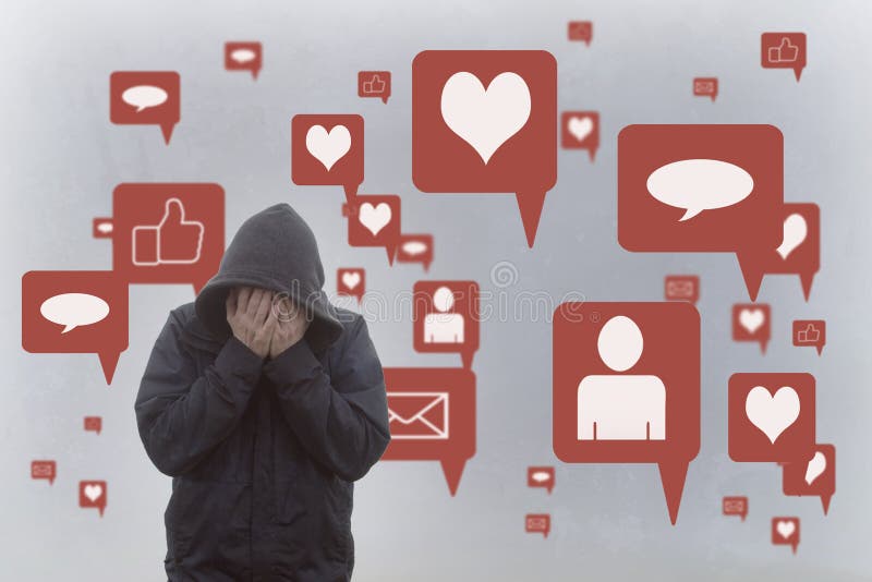 A concept of the negative effects of social media. A hooded man holding his head in his hands. With social media icons surrounding him. A concept of the negative effects of social media. A hooded man holding his head in his hands. With social media icons surrounding him