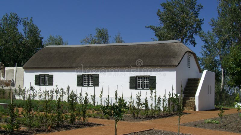 Un cottage bianco del paese del lavaggio con il tetto a lamella fotografia stock libera da diritti Un cottage bianco del paese del lavaggio con il tetto a lamella fotografia stock libera da diritti