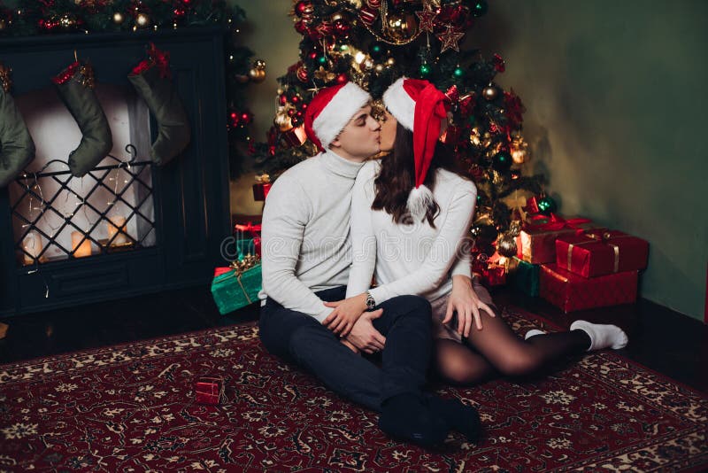 Photo De Couple S'embrassant Devant L'arbre De Noël · Photo gratuite
