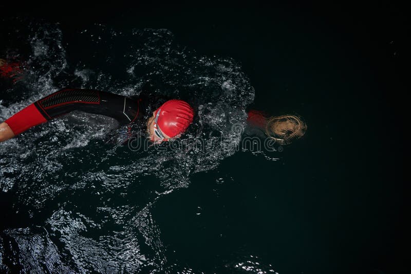 Un determinado triatleta profesional se somete a una rigurosa formación nocturna en aguas frías que exhibe dedicación y. Un determinado triatleta profesional se somete a un riguroso entrenamiento nocturno en aguas frías mostrando dedicación y resiliencia en preparación para una próxima competencia de nado triatlón.