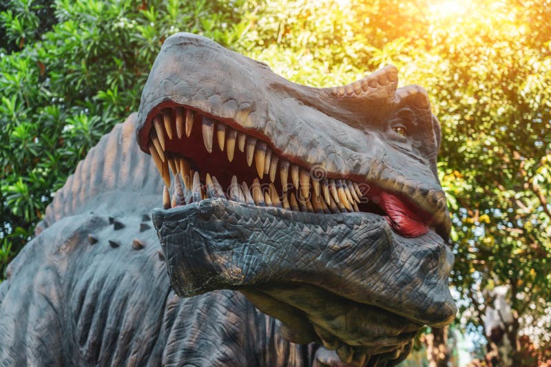 An angry predatory dinosaur in the green jungle screams and growls throughout the forest. An angry predatory dinosaur in the green jungle screams and growls throughout the forest