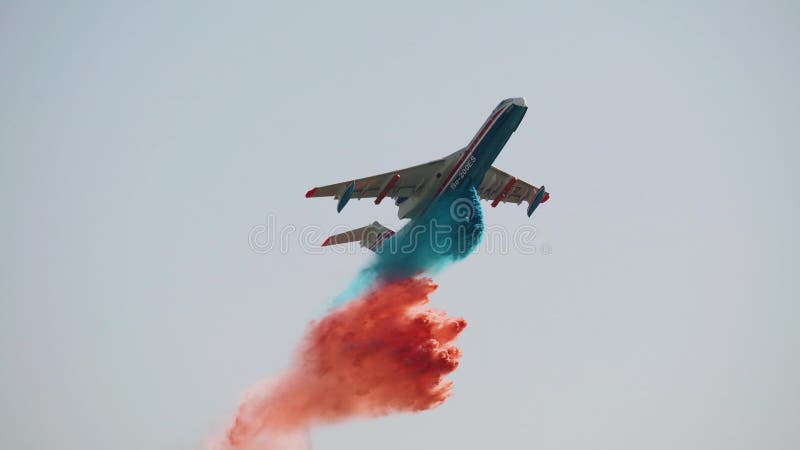 Un enorme avión de transporte arroja agua en tres colores diferentes almacen de metraje de vídeo
