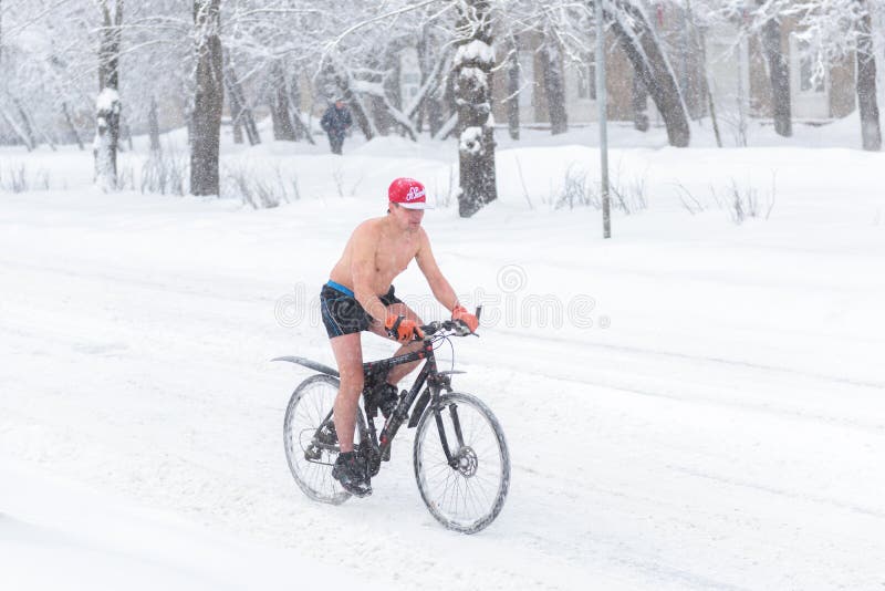 Un excentrique monte une bicyclette en hiver à Moscou image stock Un excentrique monte une bicyclette en hiver à Moscou image stock
