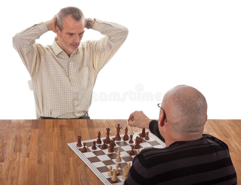 Un giocatore di scacchi checkmates l'altro immagini stock Un giocatore di scacchi checkmates l'altro immagini stock
